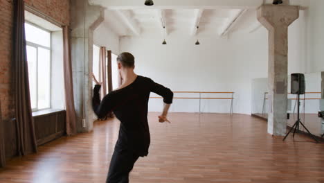 male dancer practicing in a dance studio