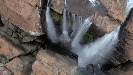 aerial: beautiful top down view of waterfall streams rapidly flowing and falling down