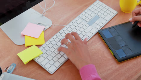 Female-graphic-designer-working-at-desk-4k