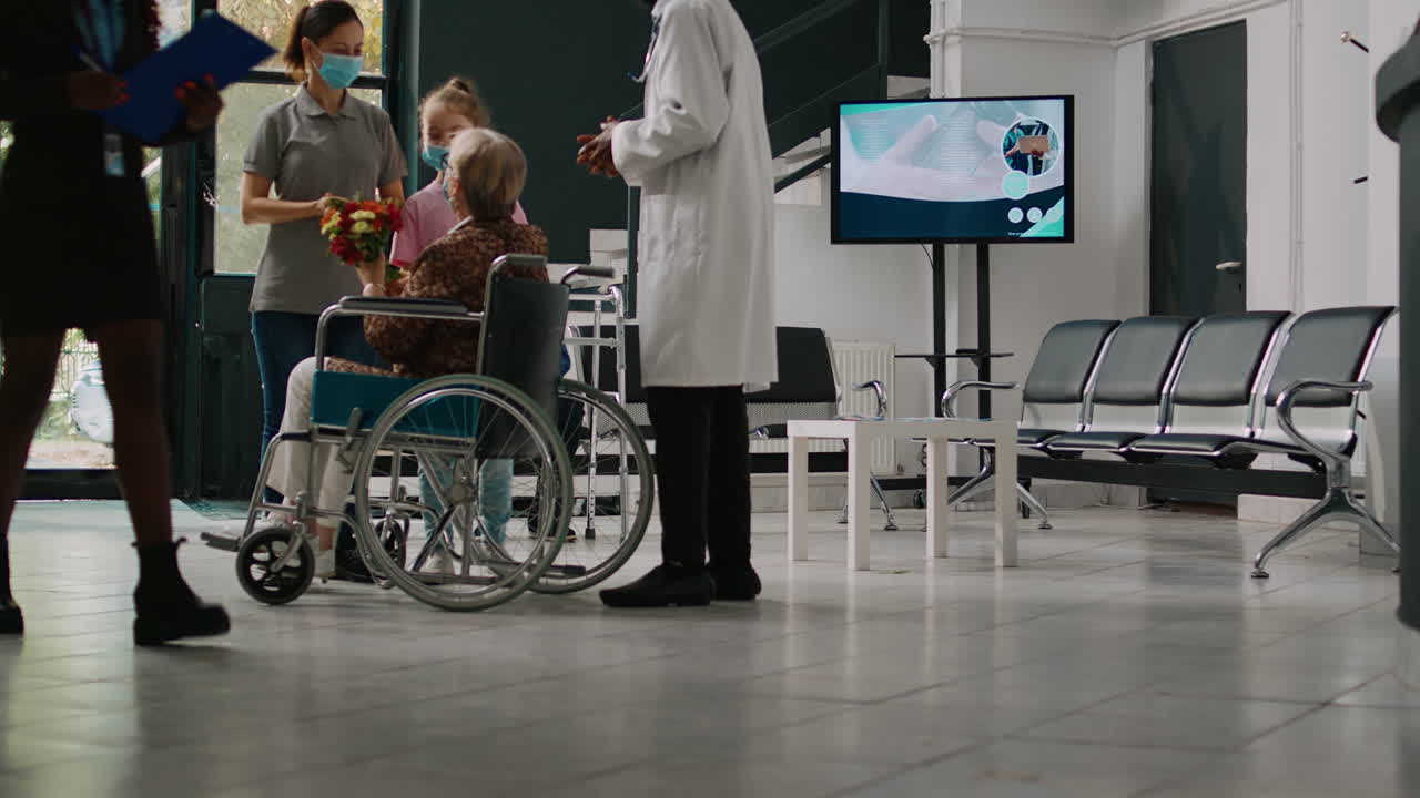 Young kid visiting old woman in wheelchair during covid 19 pandemic