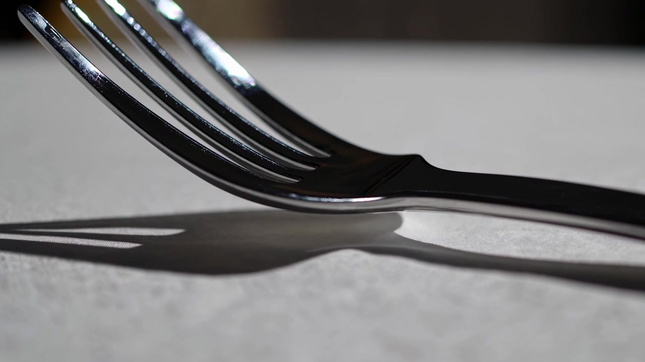Close-up of a Shiny Metal Fork on a Textured Surface