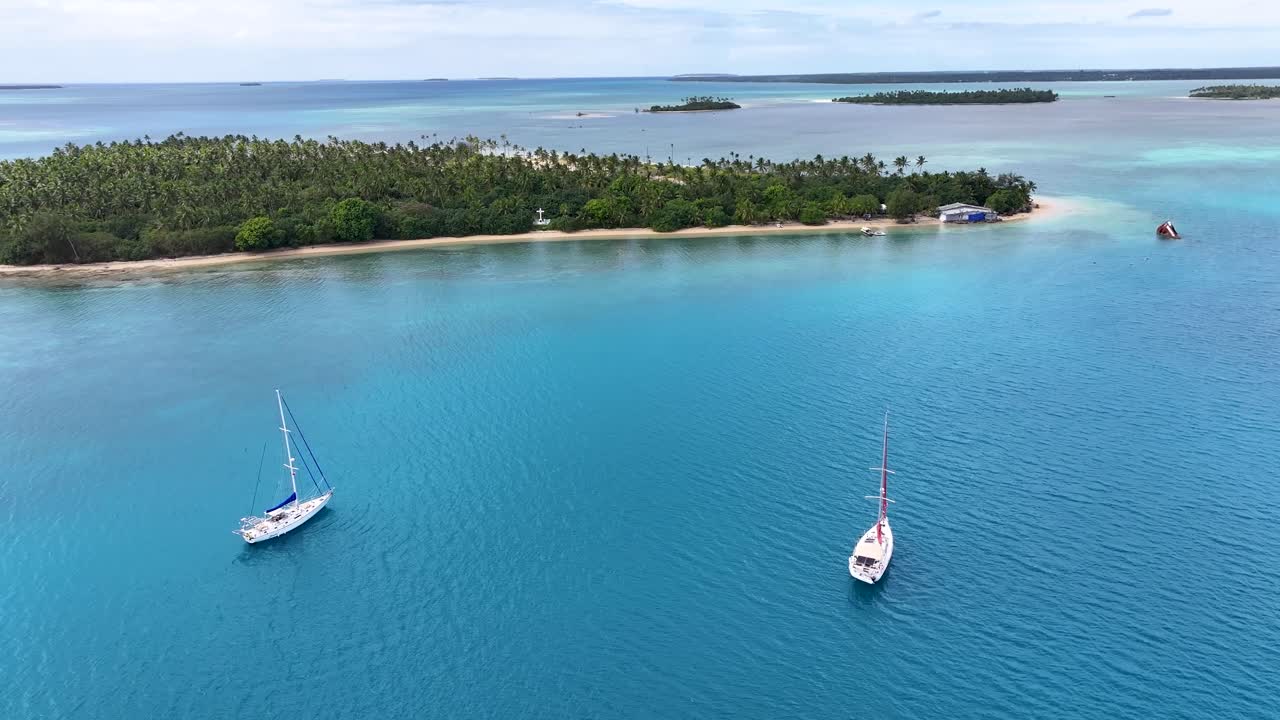 Yachts and small tropical islands scenery of Tonga. Pacific Ocean drone landscape.
