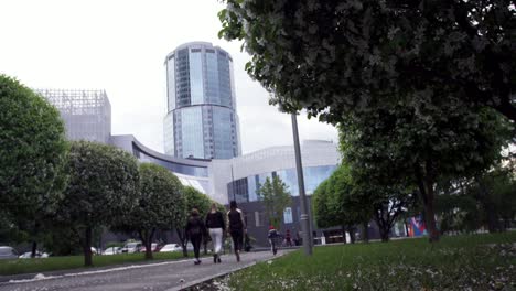 city park scene with modern buildings and people