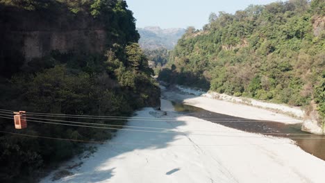 drone footage of a beautiful river floating in himalayas in hills