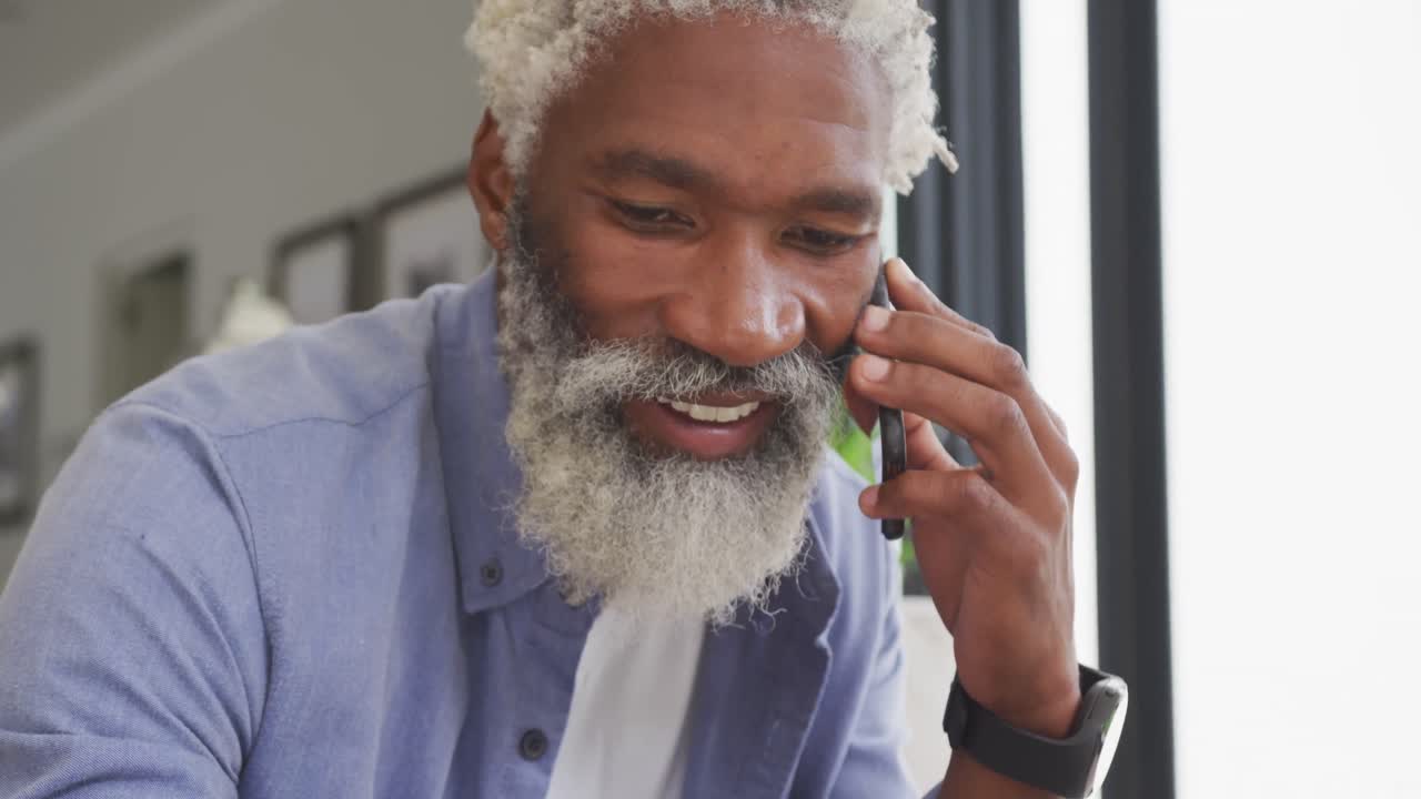 Video of african american senior man using smartphone