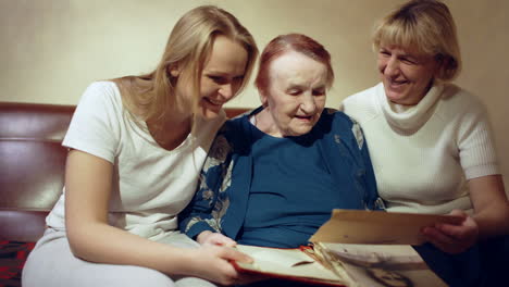 three women looking through the family archive