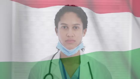 Animation-of-flag-of-hungary-with-gloved-female-doctor-putting-on-face-mask