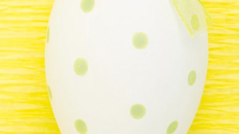 Animation-of-easter-egg-on-yellow-background