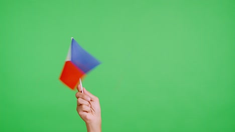 Hand waving a pennant of a philippine national flag