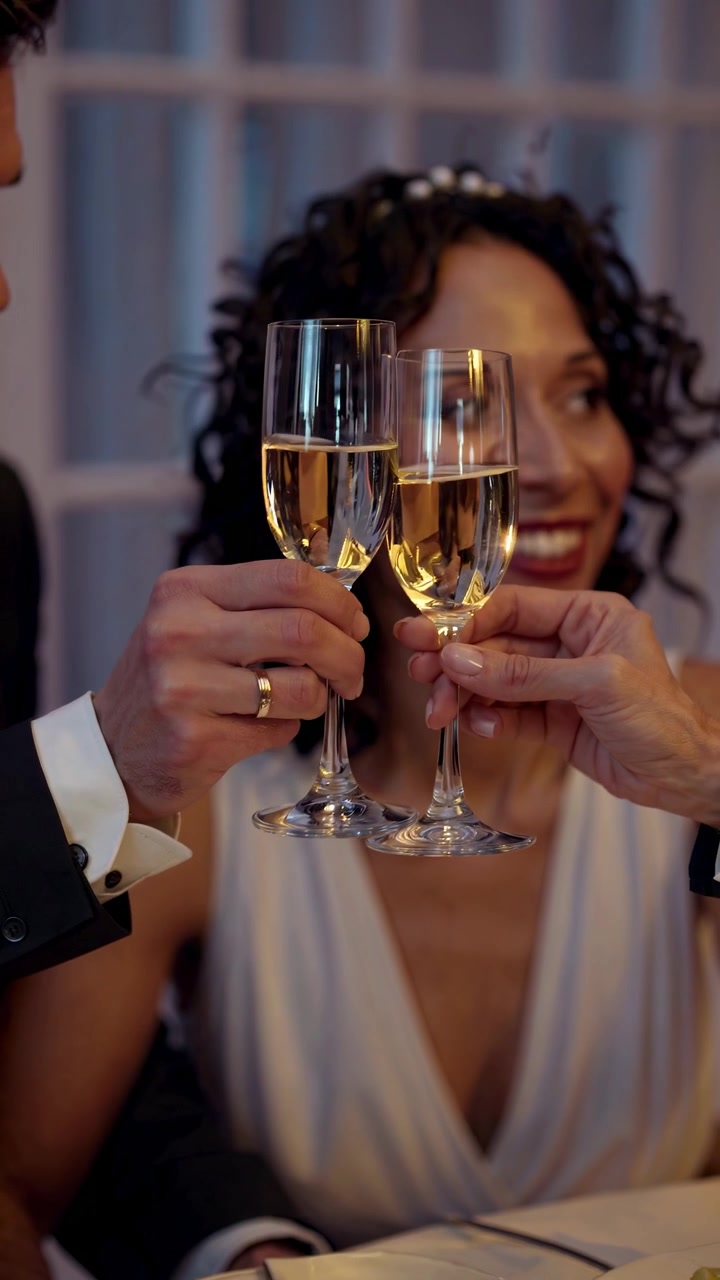 Couple Celebrating with Champagne Toast at Romantic Dinner