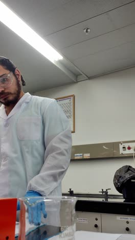 lab scientist with document and chemical setup