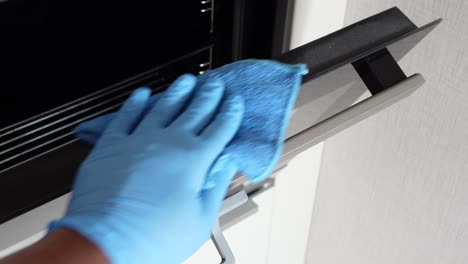 cleaning an oven with gloves