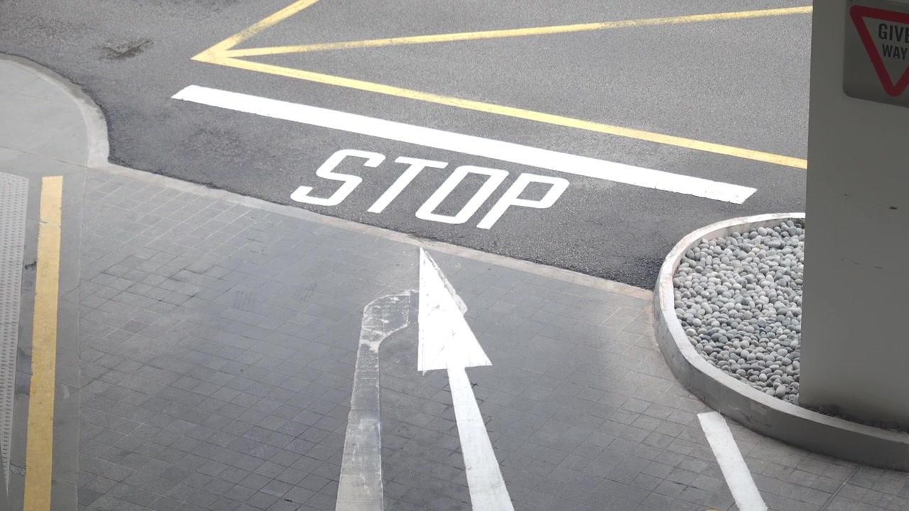 High Angle View of Road Markings and Stop Sign in Parking Lot
