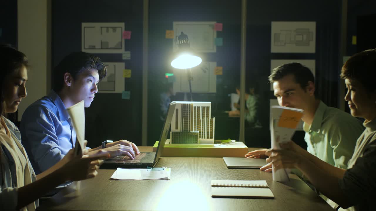 Businessman working late at night, He's the Only One Left on the Dark Office