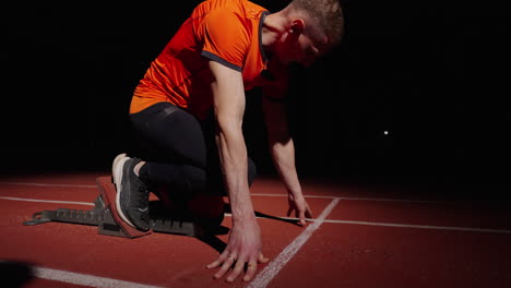 sprinter preparing for race at night