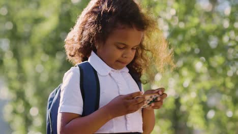 young girl on smartphone outdoors