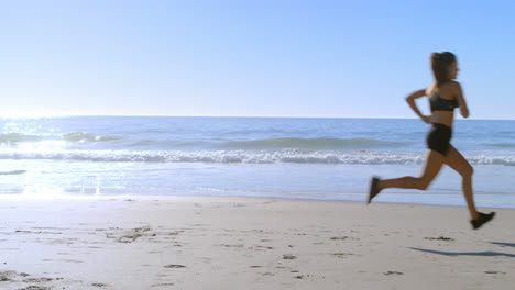 fit woman jogging in the beach 4k
