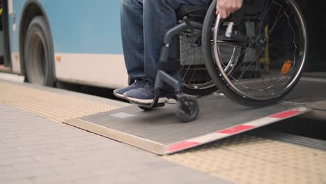 person with a physical disability leaves public transport with an accessible ramp