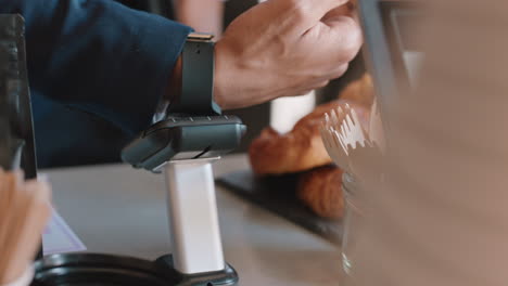 close up customer making contactless payment using smart watch mobile money transfer man buying coffee in cafe enjoying service at restaurant