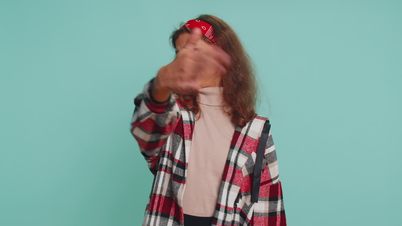 Young child girl kid closing eyes with hand showing stop gesture, confused shy scared to watch