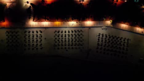 Overhead-View-Of-Sunshades-On-The-Seafront-Resort-Of-Sa-Coma-Beach-At-Night-In-Mallorca,-Spain