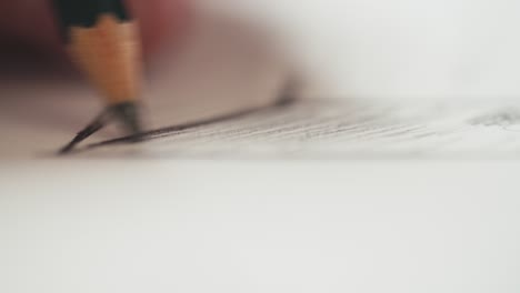 macro shot of a pencil sketching shadows on a drawing