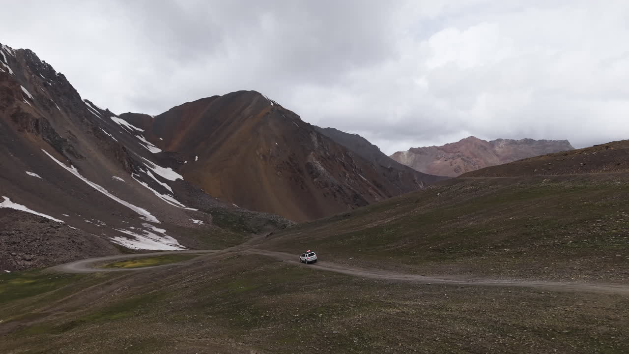 Off-Roading Near Mountainscape In The Remote Area In Kyrgyzstan, Central Asia. Aerial Drone Shot