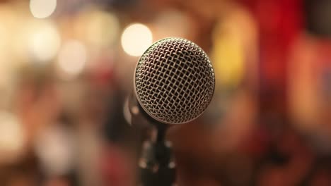 Microphone-on-stage-against-a-background-of-auditorium.