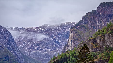 high rock mountains surrounded by clouds and mist