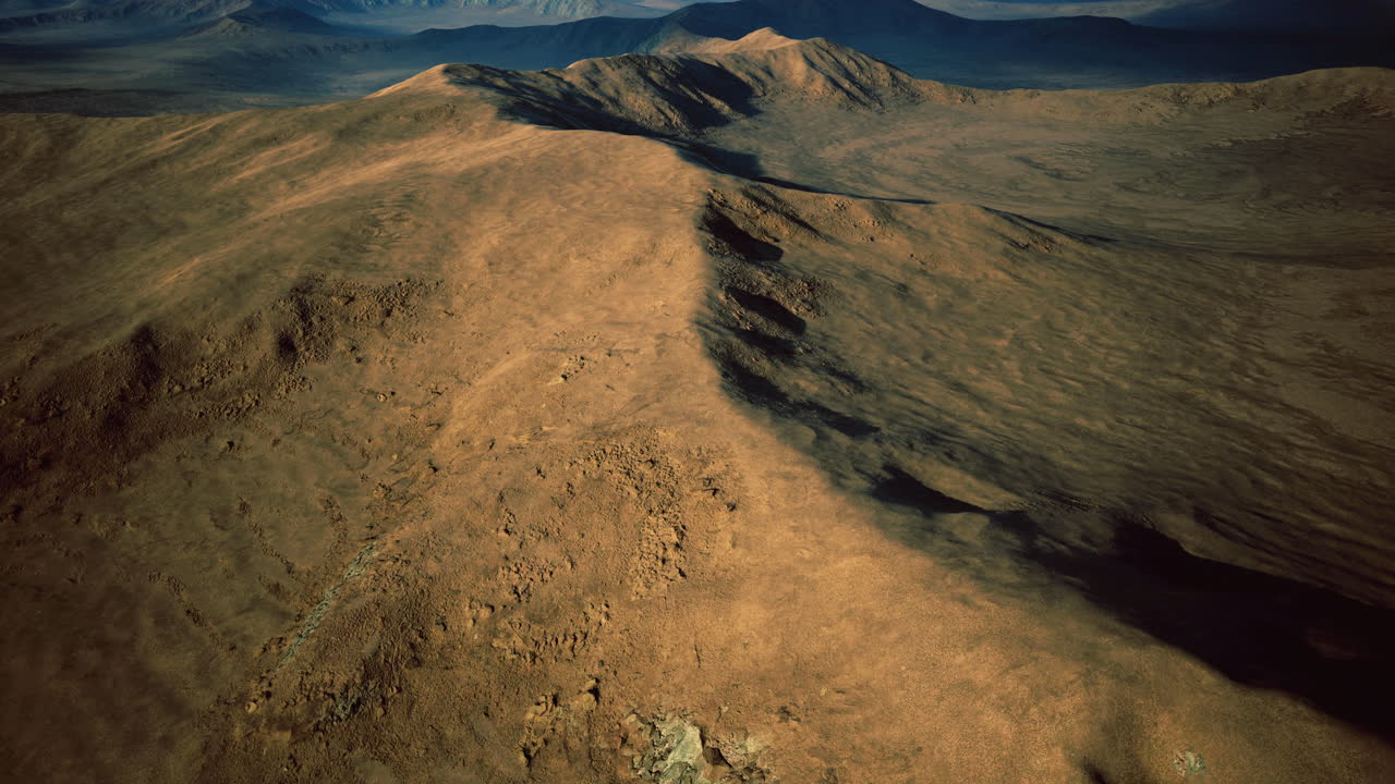 Majestic aerial view of rugged mountain terrain with dramatic shadows