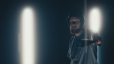 Caucasian-professional-baseball-player-batter-posing-against-dark-background.-4K-UHD-60-FPS-SLOW-MOTION