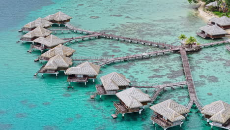 Huahine Island, French Polynesia. Aerial View of Overwater Villas of Luxury Resort, Lagoon and Coastal Landscape