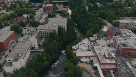 The-Magog-River-Flows-Through-the-City-of-Sherbrooke-in-Quebec,-Canada---Aerial-Drone-Shot