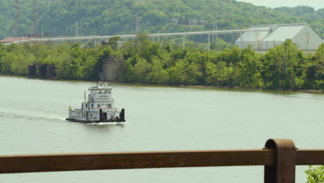 a-tugboat-cruising-along-the-river-in-an-industrial-are-of-Pennsylvania