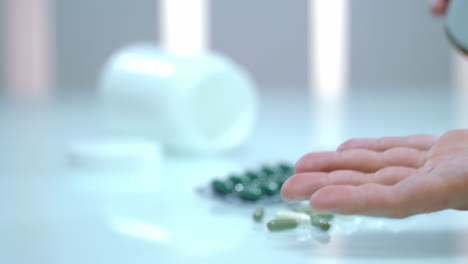 pharmaceutical medicine concept, man taking various pills on male hand pouring tablets from meds bottle. taking medicine, health care and treatment concept.