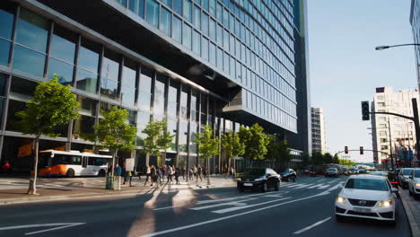 daytime city street with modern buildings and traffic