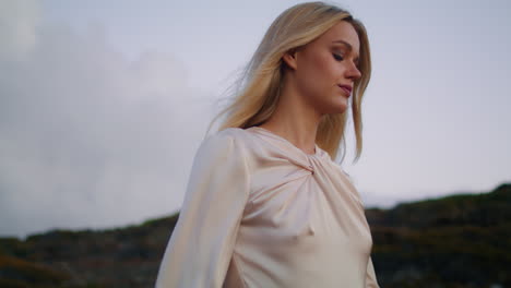 serious girl walk nature vertical closeup. thoughtful woman moving sunset hill