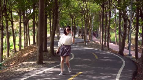 Young-Asian-woman-having-fun-in-urban-park