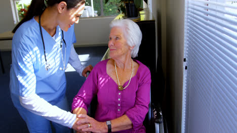 Front-view-of-Caucasian-female-doctor-consoling-sad-disabled-senior-woman-at-nursing-home-4k