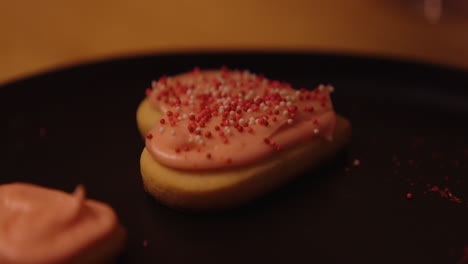 heart-shaped cookies with pink frosting and sprinkles