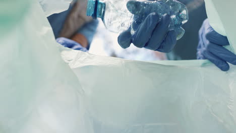 medical professional disposing of medical waste in a plastic bag