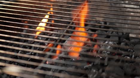 empty-charcoal-grill-with-grate-and-burning-fire