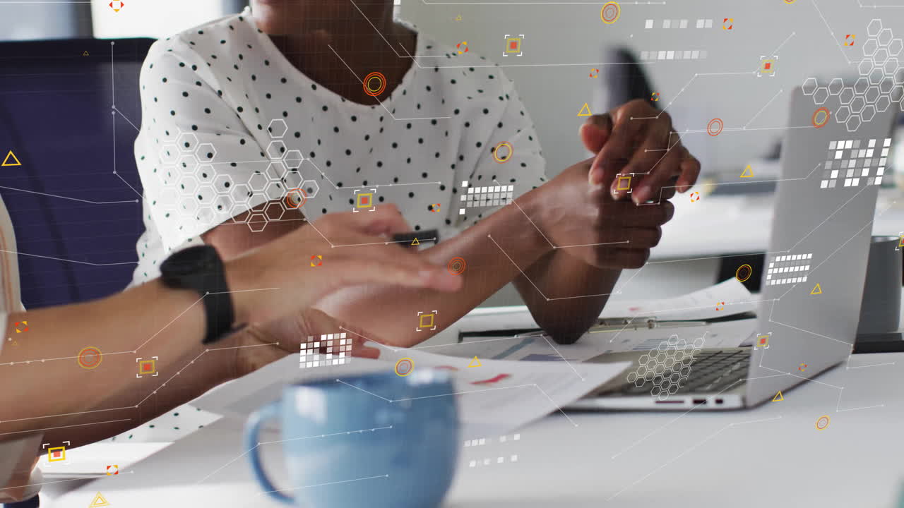 Animation of processing data over happy diverse female colleagues using laptop at casual office