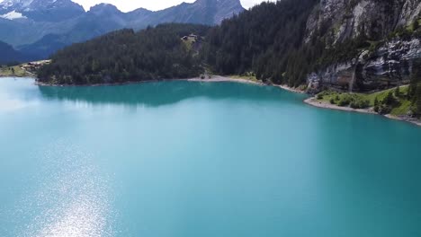 Drone-aerial-view-of-Brienz-Lake-against-mountains,-valleys-and-meadows-in-Switzerland