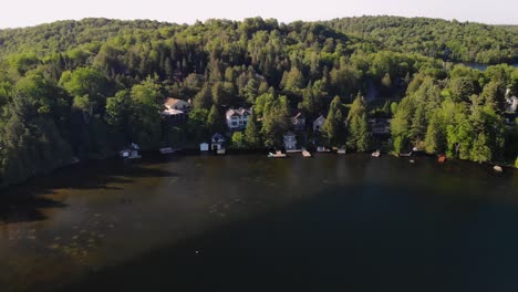 4k aerial drone cottage house lake flying forward over cottages