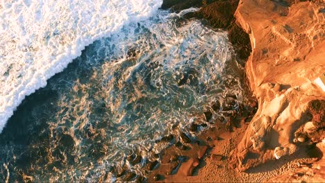 waves crash over rocks at the la jolla coastline in san diego