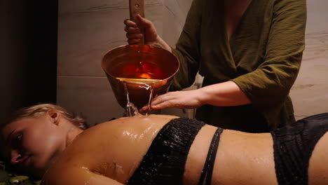 woman receiving a back massage in a turkish bath