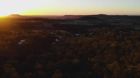 The-camera-flies-past-a-man-bathed-in-the-warm-sunset-glow-and-flies-into-the-valley