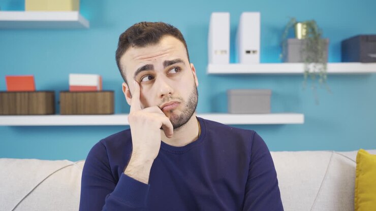Portrait of confused thoughtful young man.