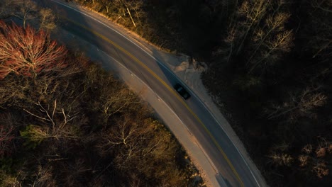 spinning over cars passing along a lakeshore route